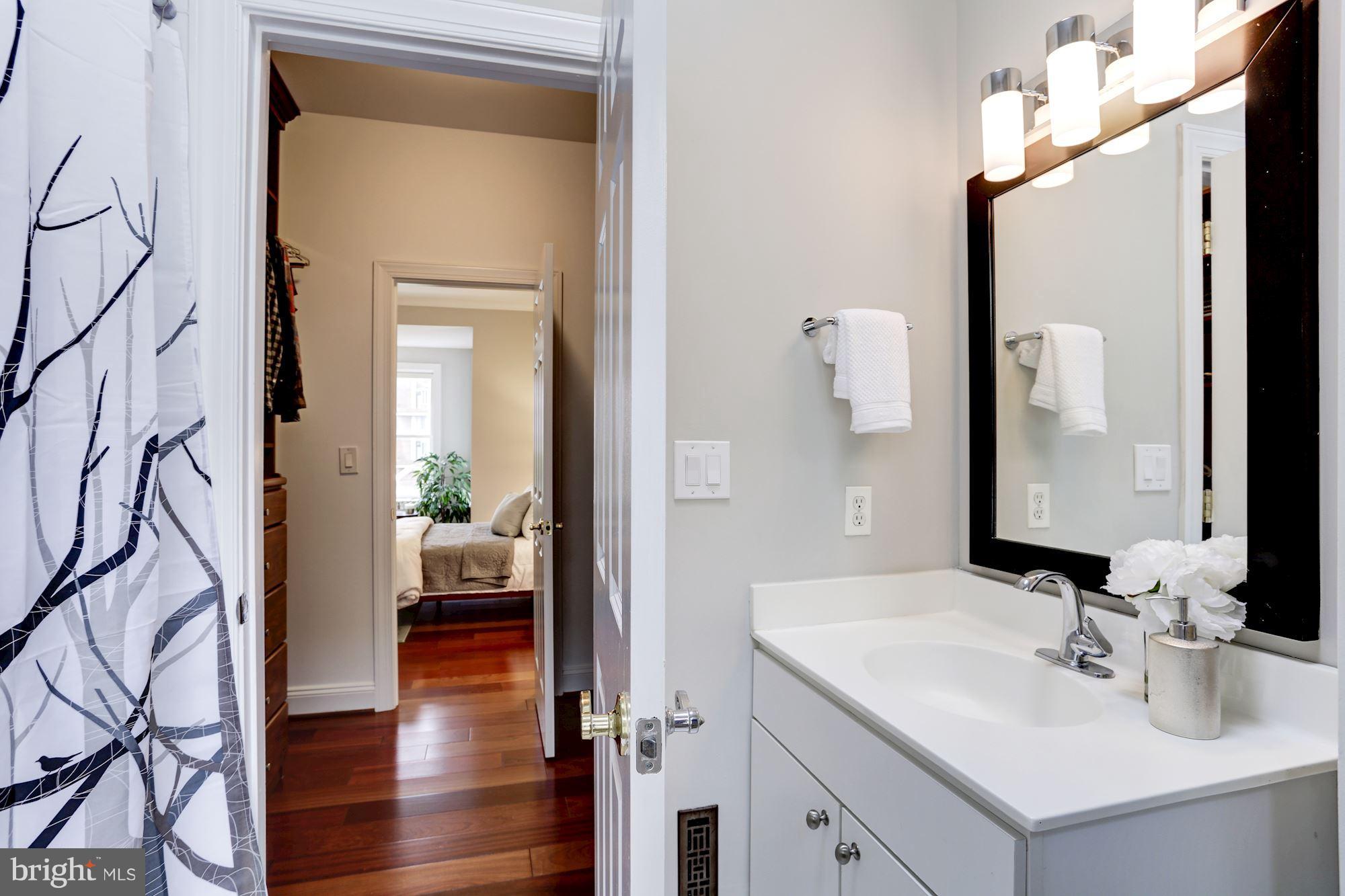 1229 12th Street Northwest, Unit 201 Washington, DC 20005 - Photo 20 of 29 a en suite bathroom with a sink and a mirror