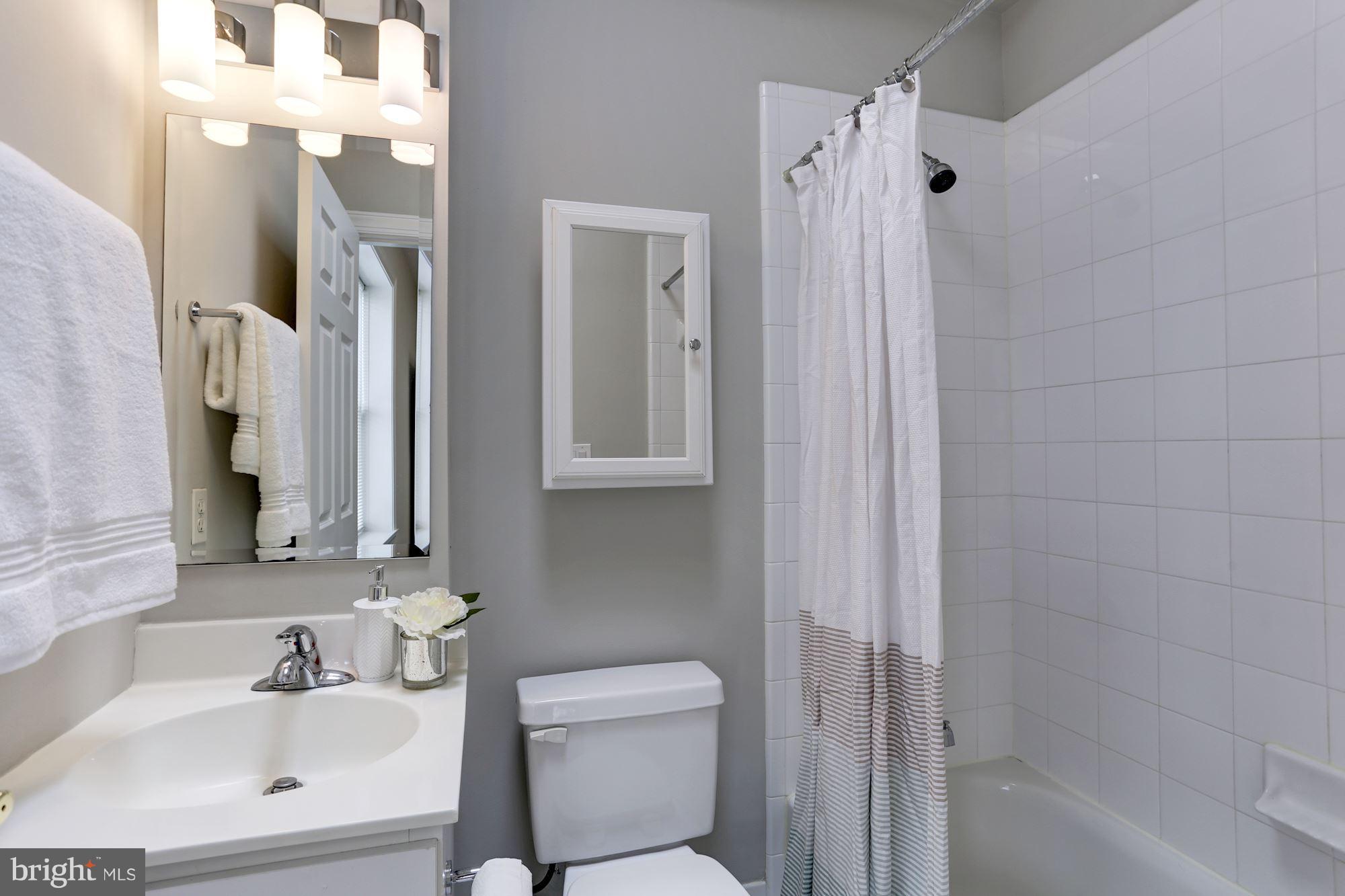 1229 12th Street Northwest, Unit 201 Washington, DC 20005 - Photo 23 of 29 a bathroom with a sink toilet and shower