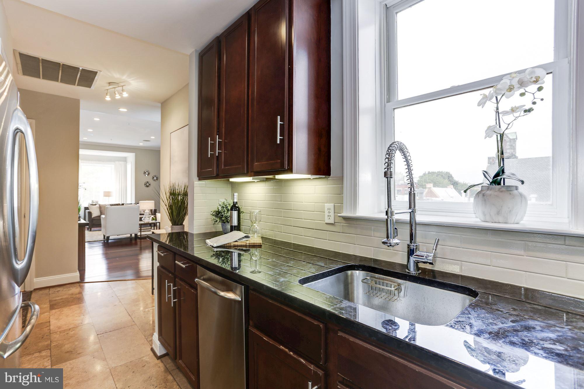 1229 12th Street Northwest, Unit 201 Washington, DC 20005 - Photo 8 of 29 a kitchen with a sink and a stove top oven