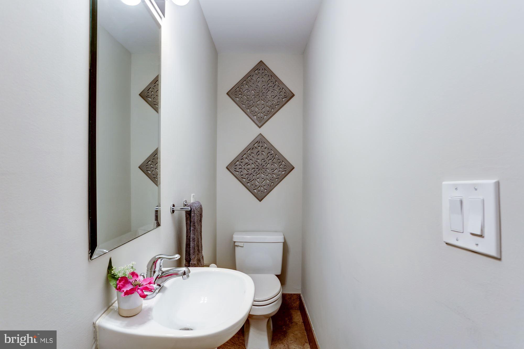 1229 12th Street Northwest, Unit 201 Washington, DC 20005 - Photo 9 of 29 a bathroom with a toilet a sink and a mirror