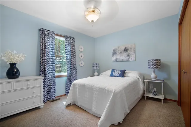 a bedroom with a bed and a chair