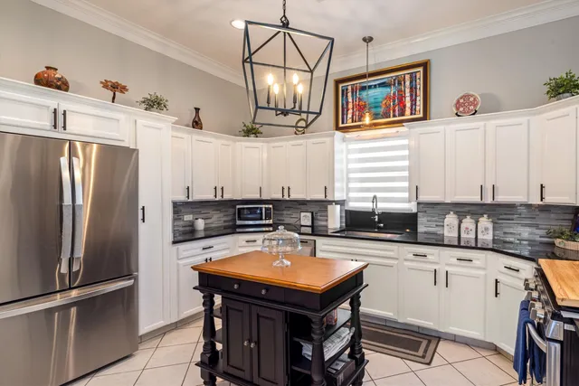 a kitchen with a refrigerator a sink and dishwasher with wooden floor