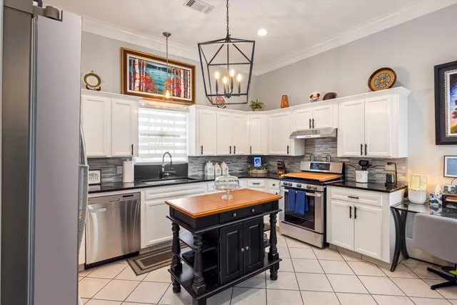 a kitchen with stainless steel appliances a stove sink and microwave