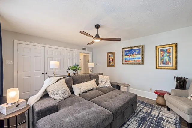 a living room with furniture and wooden floor
