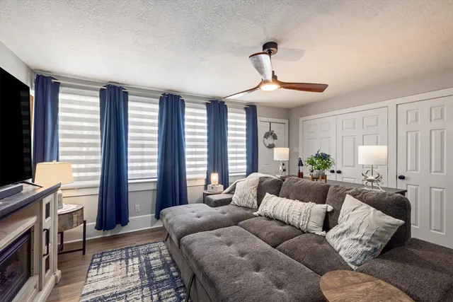 a living room with furniture a chandelier and a window
