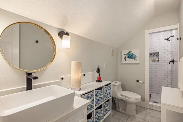 a bathroom with a sink toilet and a mirror