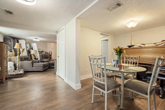 a view of a dining room with furniture and wooden floor