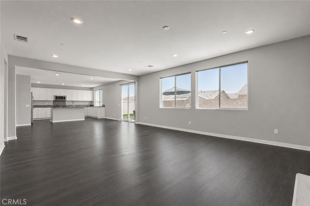 11056 Guffey Ranch Way Corona, CA 92883 - Photo 52 of 61 an empty room with wooden floor and windows