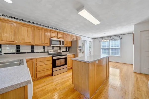 a spacious bedroom with a bed and a flat screen tv