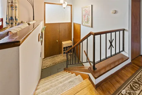 a kitchen with stainless steel appliances granite countertop lots of counter top space and wooden floors