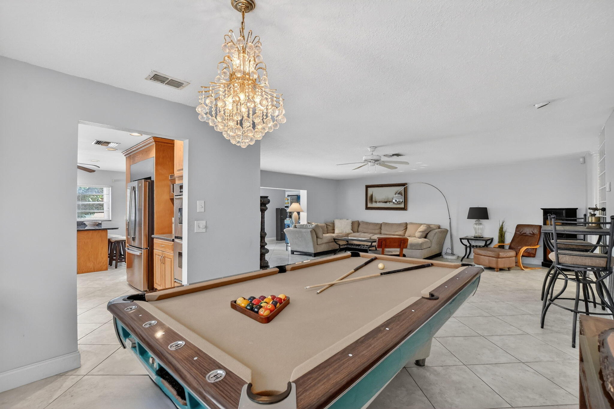 23153 Southwest 60th Way Boca Raton, FL 33428 - Photo 15 of 57 a living room with furniture and a chandelier