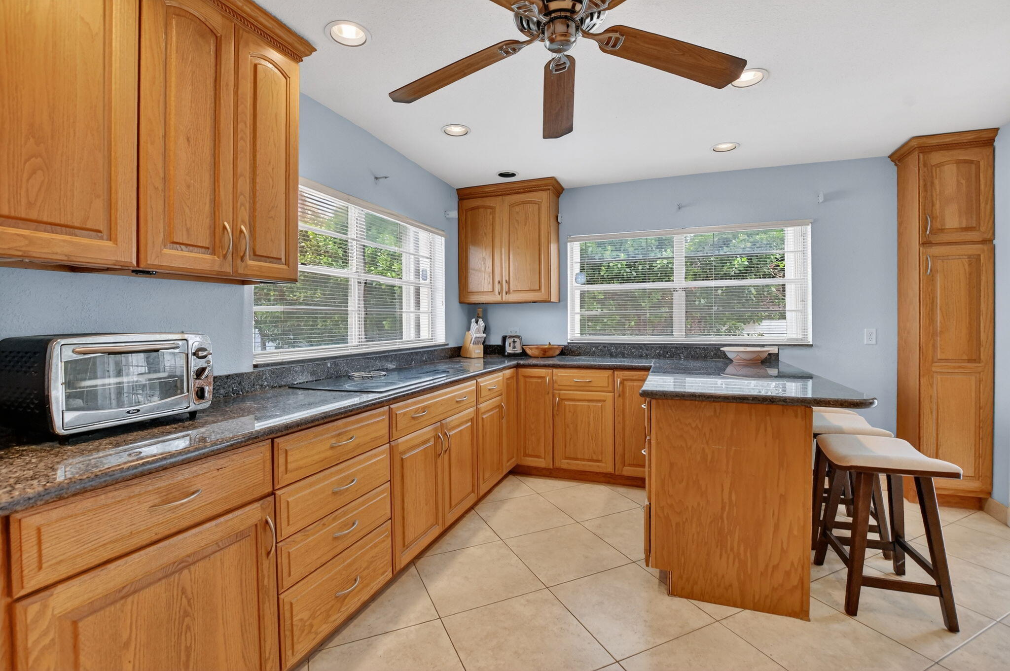 23153 Southwest 60th Way Boca Raton, FL 33428 - Photo 16 of 57 a kitchen with granite countertop lots of counter top space and windows