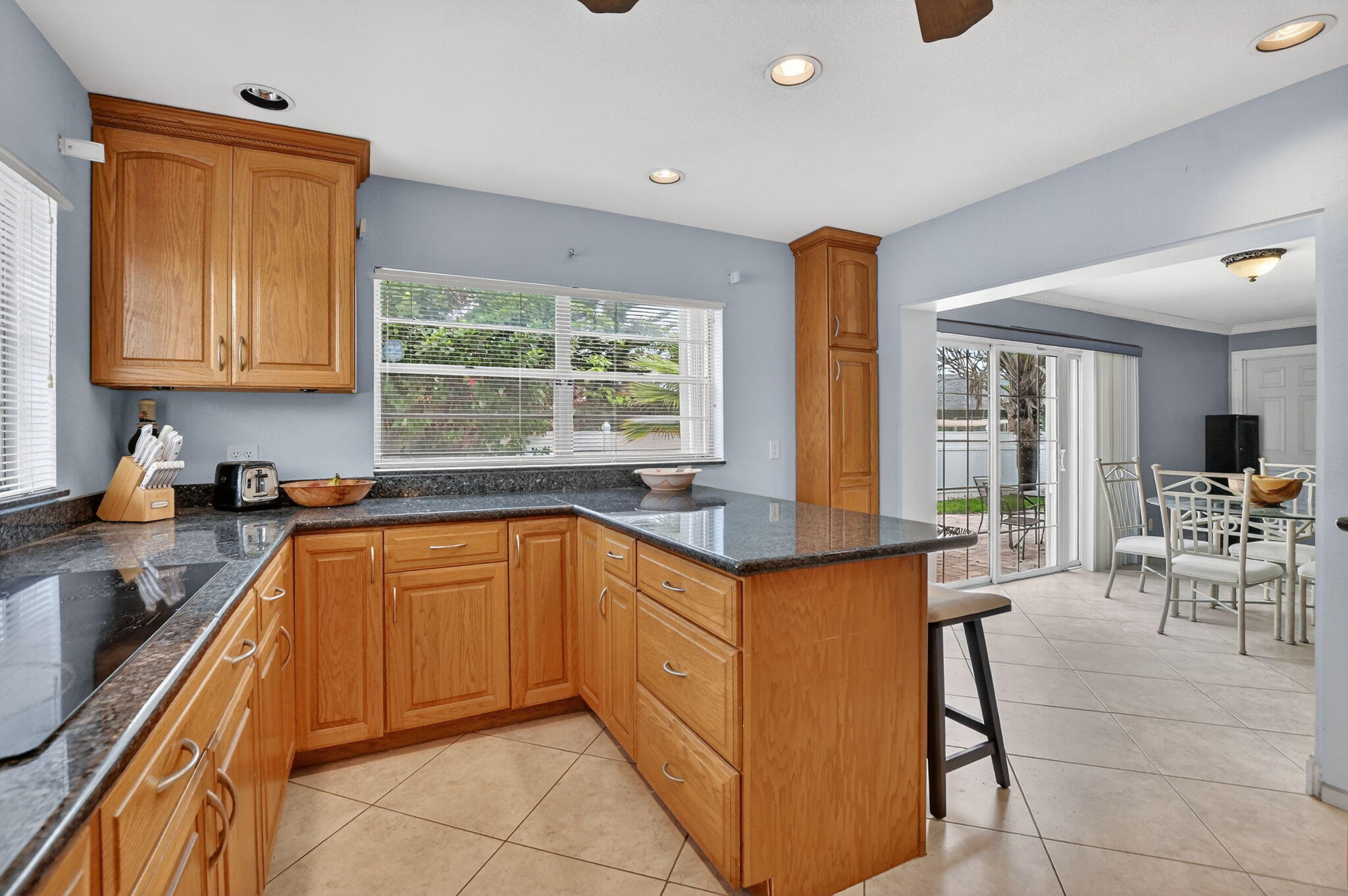 23153 Southwest 60th Way Boca Raton, FL 33428 - Photo 17 of 57 a kitchen with stainless steel appliances granite countertop sink microwave and window