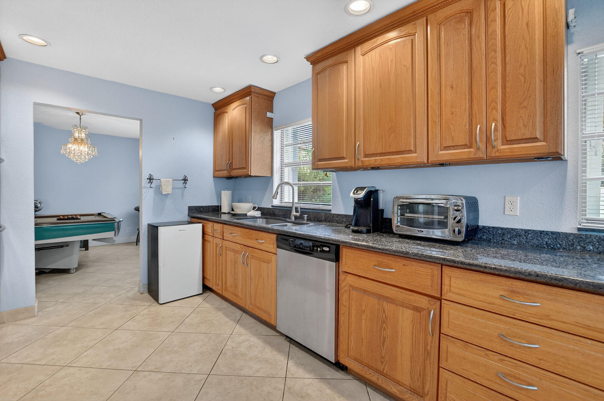 23153 Southwest 60th Way Boca Raton, FL 33428 - Photo 19 of 57 a kitchen with stainless steel appliances granite countertop a sink and cabinets