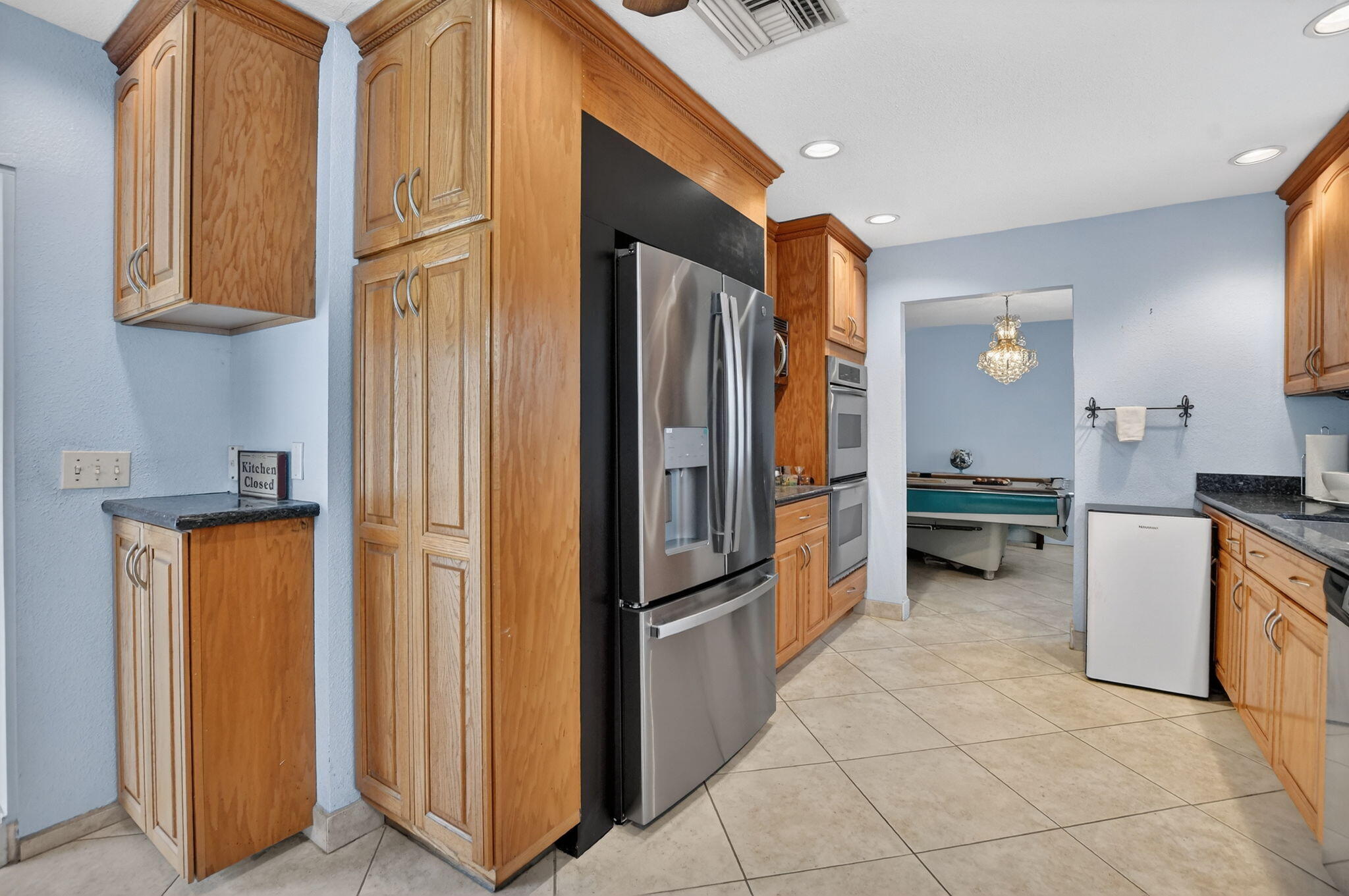 23153 Southwest 60th Way Boca Raton, FL 33428 - Photo 20 of 57 a kitchen with stainless steel appliances granite countertop a refrigerator and a sink