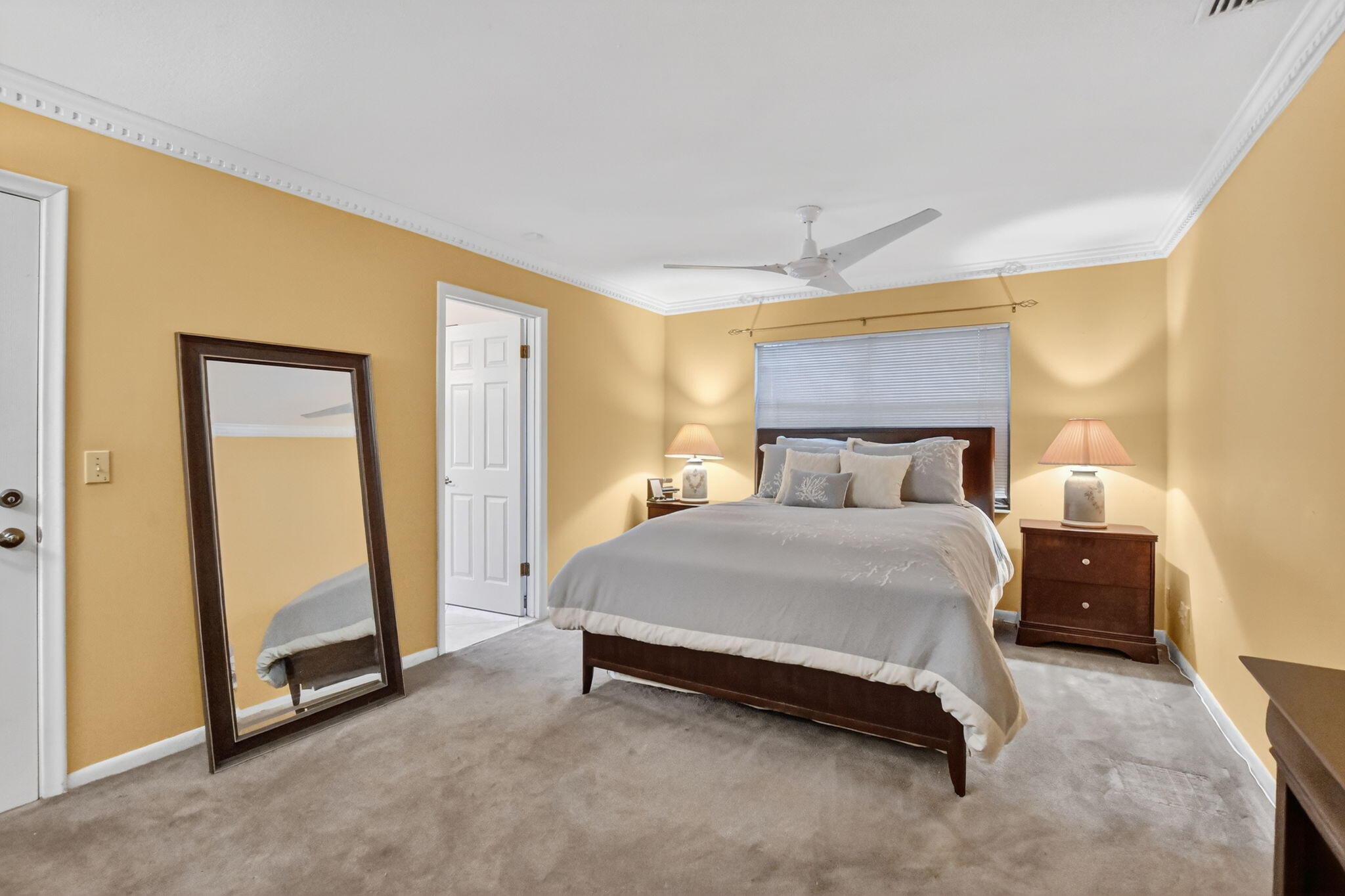 23153 Southwest 60th Way Boca Raton, FL 33428 - Photo 26 of 57 a spacious bedroom with a bed and a refrigerator