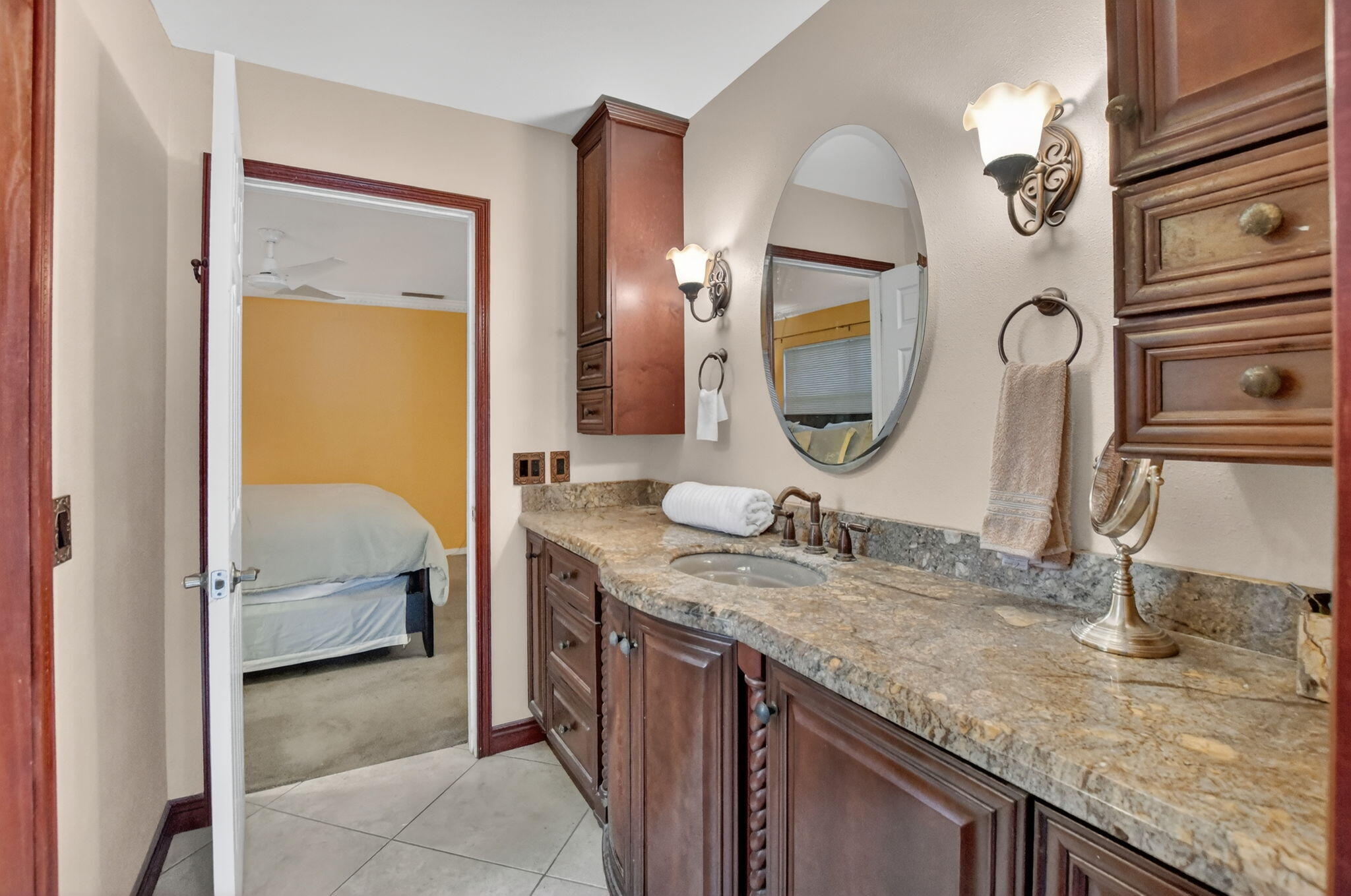 23153 Southwest 60th Way Boca Raton, FL 33428 - Photo 29 of 57 a en suite bathroom with a granite countertop sink and a mirror