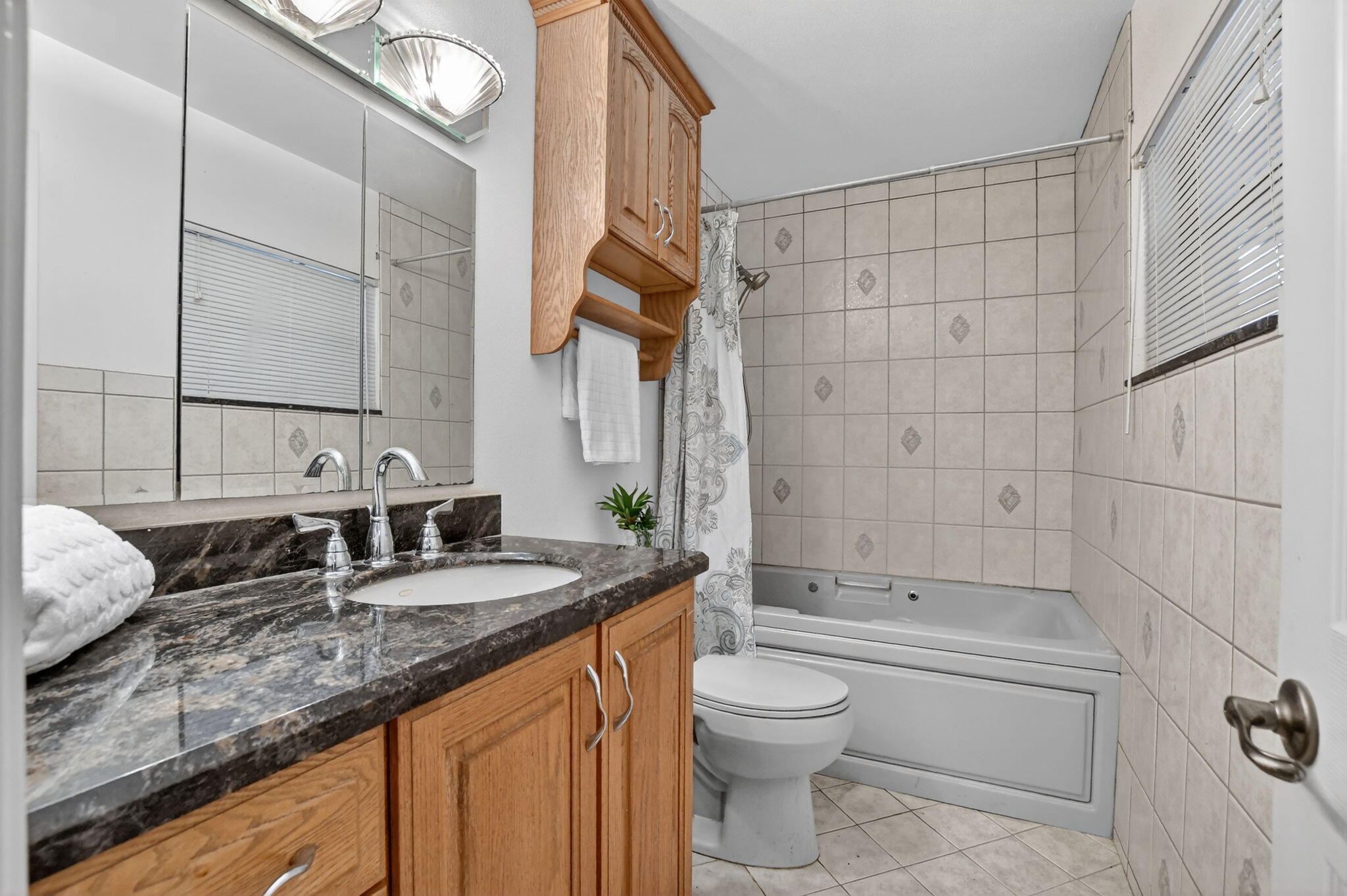23153 Southwest 60th Way Boca Raton, FL 33428 - Photo 35 of 57 a bathroom with a granite countertop sink a toilet and shower