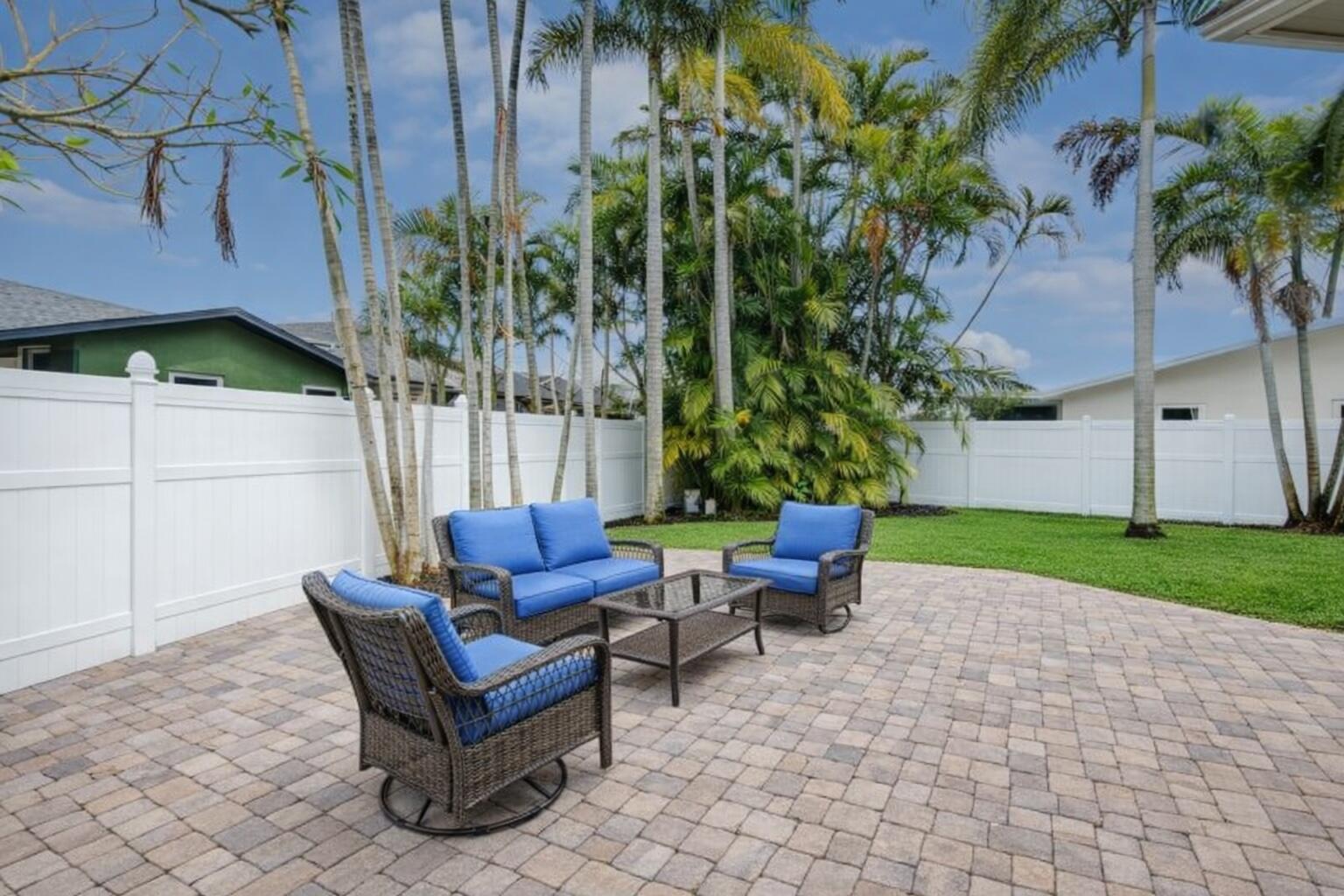 23153 Southwest 60th Way Boca Raton, FL 33428 - Photo 45 of 57 a backyard of a house with table and chairs