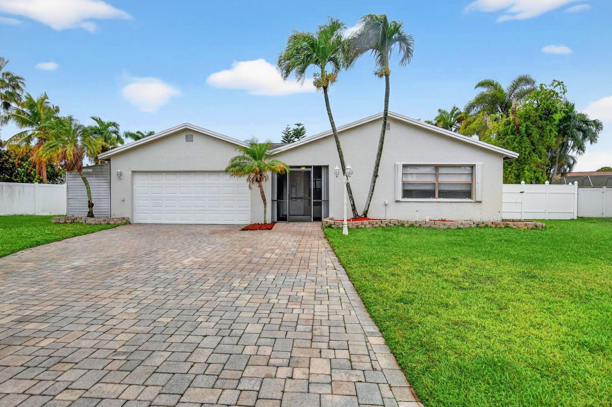 23153 Southwest 60th Way Boca Raton, FL 33428 - Photo 55 of 57 a view of a house with a yard and palm trees