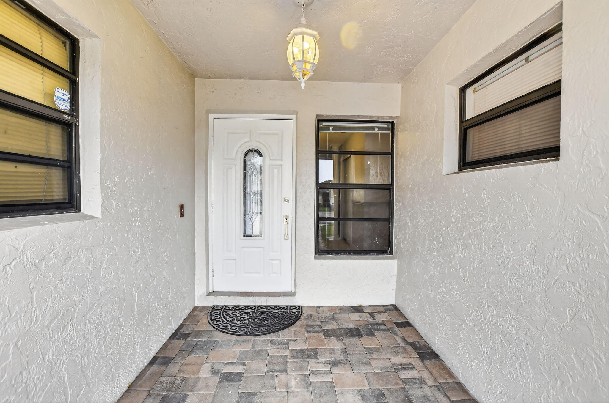 23153 Southwest 60th Way Boca Raton, FL 33428 - Photo 6 of 57 a view of a hallway with wooden floor and a chandelier