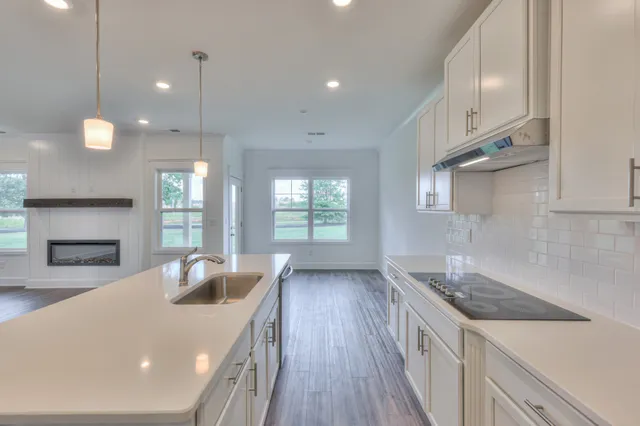 a kitchen with a sink and chandelier