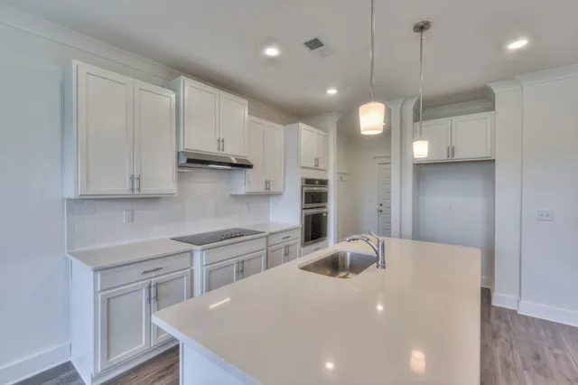 a kitchen that has a microwave a sink and a stove