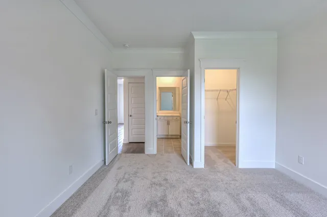 a bathroom with a bathtub shower sink vanity mirror and toilet