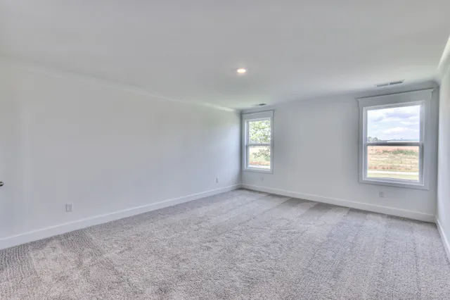 a spacious bathroom with a double vanity sink a large mirror and a shower