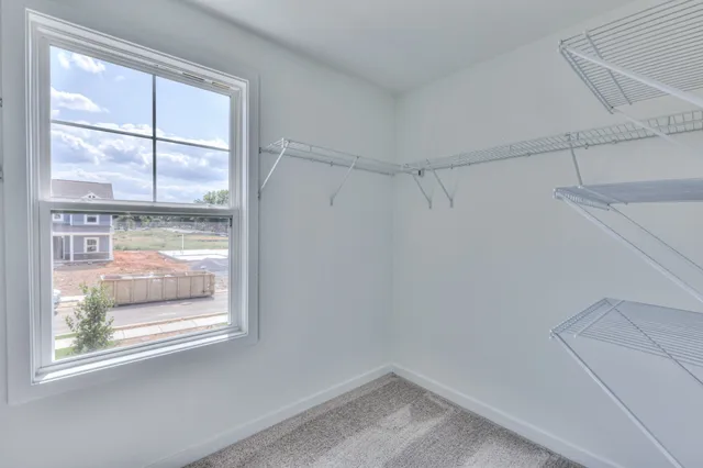 a spacious bathroom with double sink a mirror and a shower