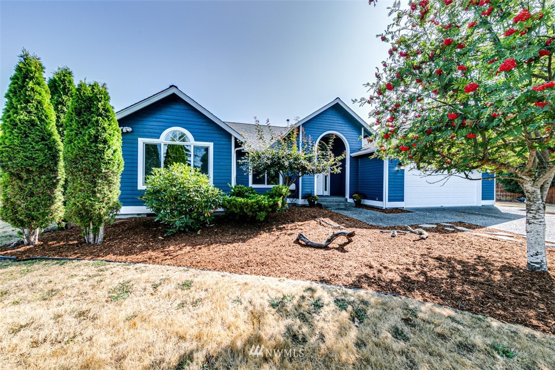 64 Bon Jon View Way Sequim, WA 98382 - Photo 3 of 40 a front view of a house with a yard and garage