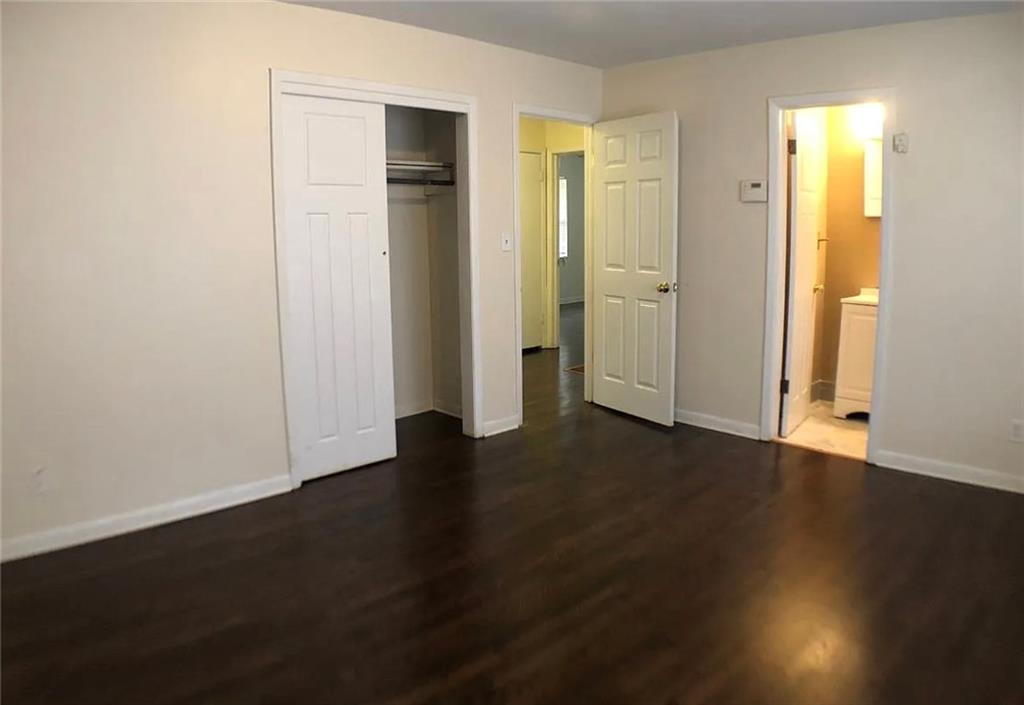 1457 Janmar Drive Decatur, GA 30032 - Photo 3 of 9 an empty room with wooden floor and windows