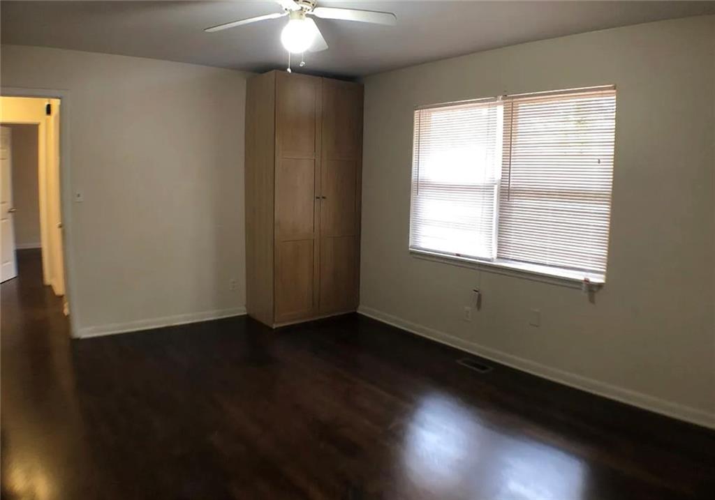 1457 Janmar Drive Decatur, GA 30032 - Photo 4 of 9 a view of an empty room with wooden floor and a window
