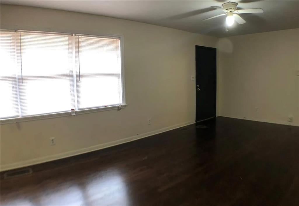 1457 Janmar Drive Decatur, GA 30032 - Photo 5 of 9 a view of an empty room with wooden floor and a window