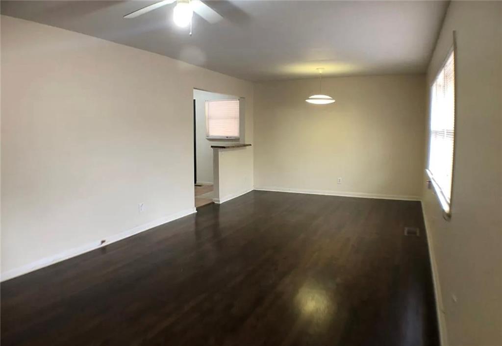 1457 Janmar Drive Decatur, GA 30032 - Photo 6 of 9 an empty room with wooden floor and windows