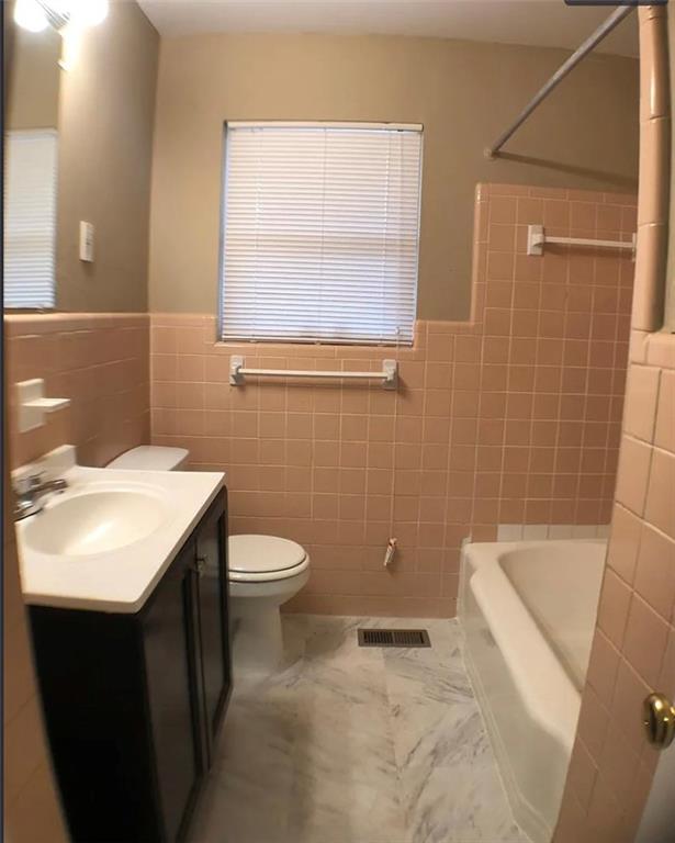 1457 Janmar Drive Decatur, GA 30032 - Photo 7 of 9 a bathroom with a sink a toilet and shower