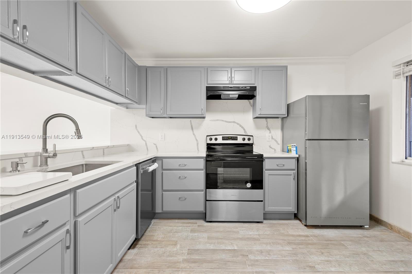 a kitchen with a refrigerator sink and cabinets
