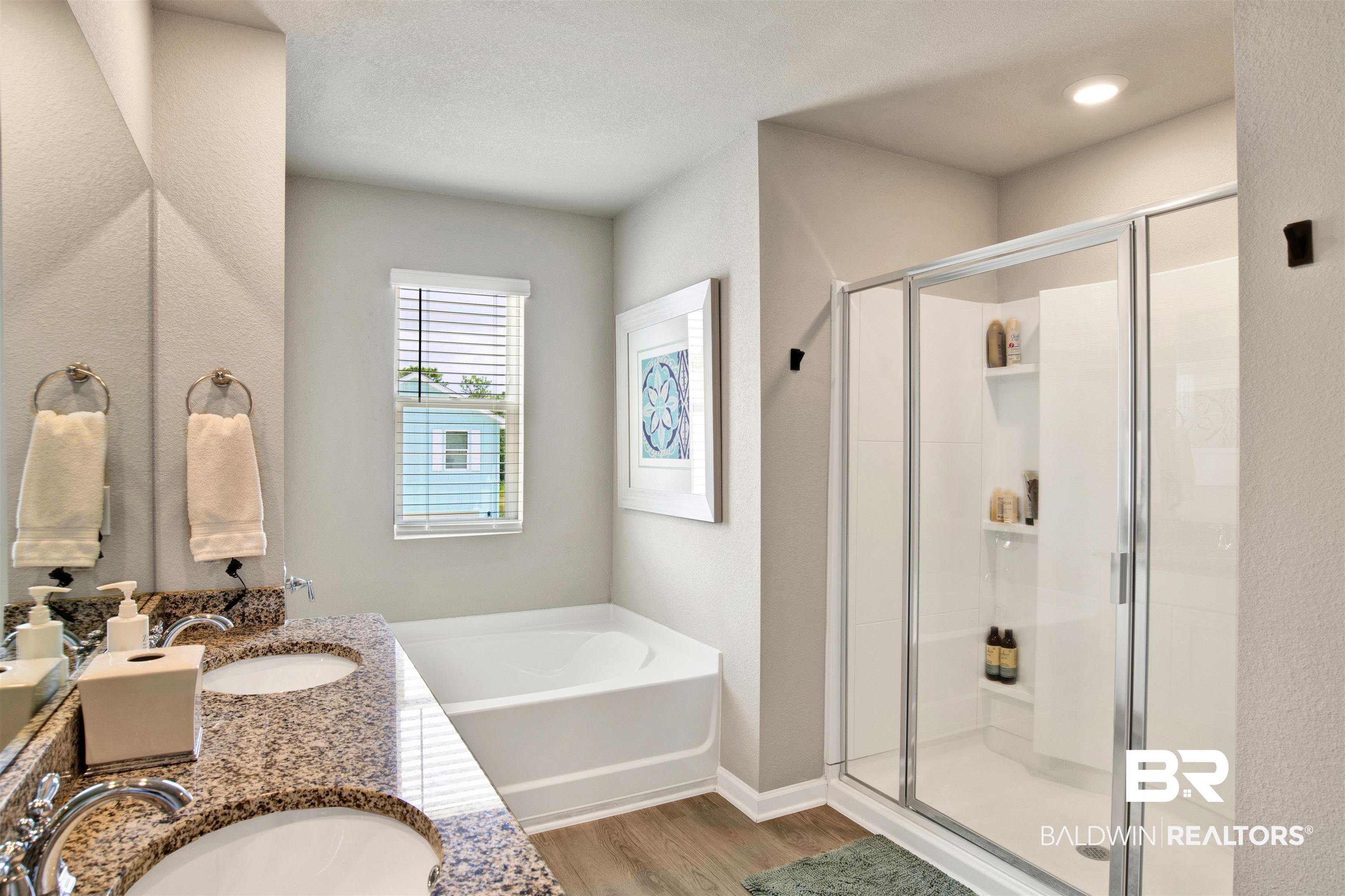 24532 Broken Sound Loop Orange Beach, AL 36561 - Photo 18 of 29 Bathroom featuring hardwood / wood-style floors, a textured ceiling, separate shower and tub, and dual vanity