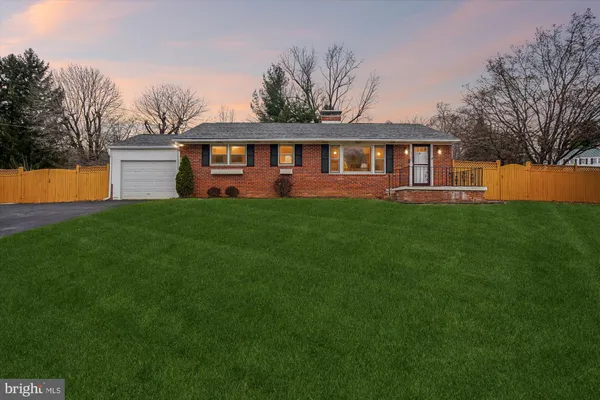 a front view of a house with yard and green space