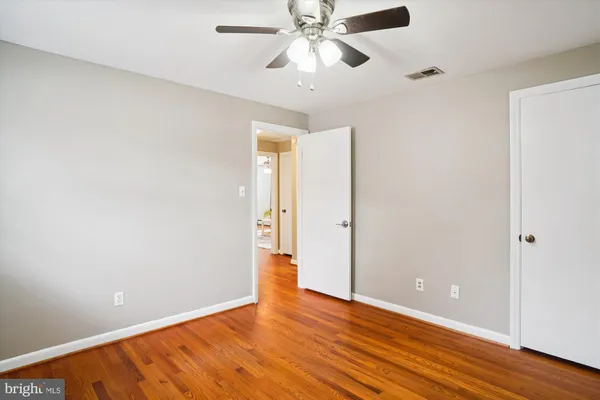 a view of an empty room with wooden floor