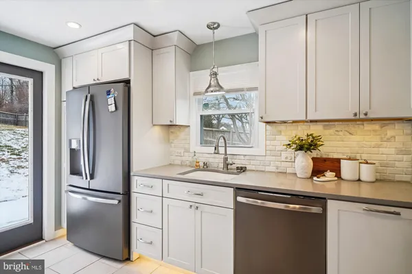 a kitchen with stainless steel appliances granite countertop a refrigerator sink and cabinets