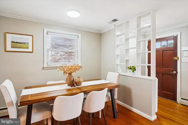 a view of a dining room with furniture window and wooden floor