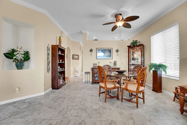 a spacious en suite bathroom with a granite countertop sink and mirror