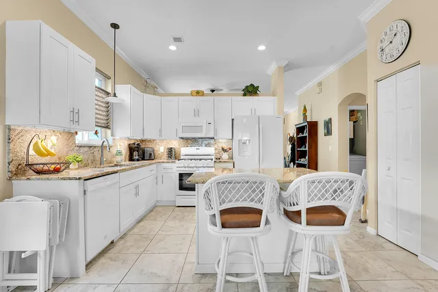 a kitchen with stainless steel appliances granite countertop a sink and cabinets