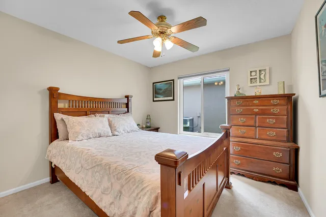 a bedroom with a bed and a painting on the wall