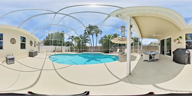 a view of backyard with swimming pool and outdoor seating