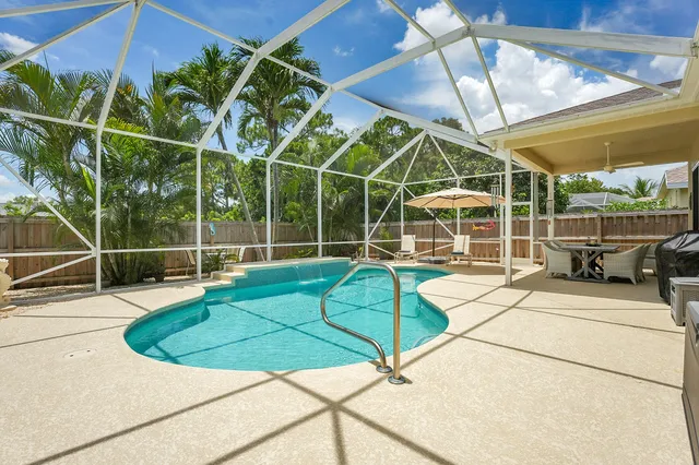 a view of an outdoor dining space with a table and chairs