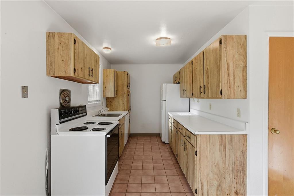 93 Stonesipher Road Oakdale, PA 15071 - Photo 13 of 36 a kitchen with stainless steel appliances a stove a sink dishwasher and a refrigerator