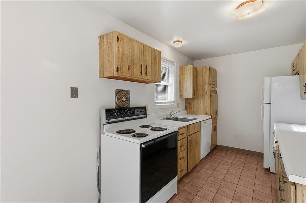 93 Stonesipher Road Oakdale, PA 15071 - Photo 14 of 36 a kitchen with stainless steel appliances granite countertop a stove and a refrigerator