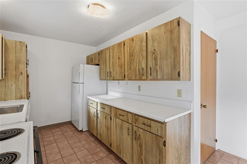 93 Stonesipher Road Oakdale, PA 15071 - Photo 15 of 36 a utility room with a sink a cabinetry and a refrigerator